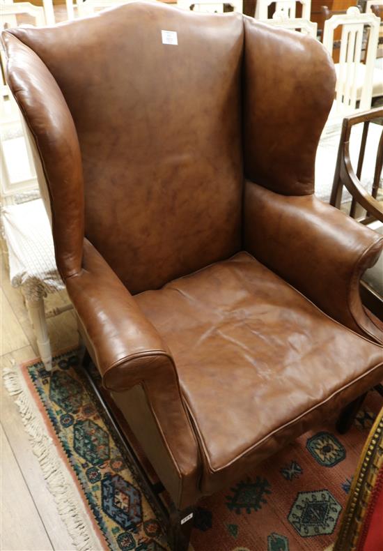 A George III style mahogany wingback armchair